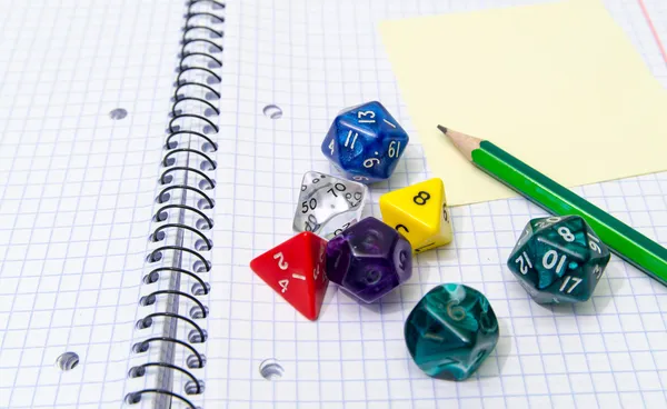 Role playing dices lying on exercise book