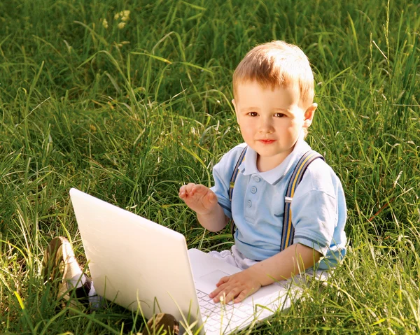 Child with laptop in nature