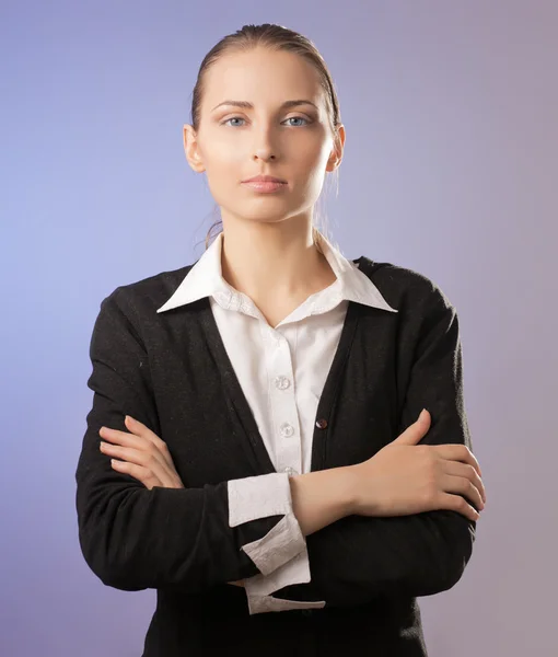 Businesswoman standing with folded arms.