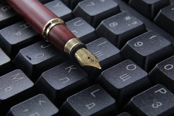 Pen on computer keyboard.