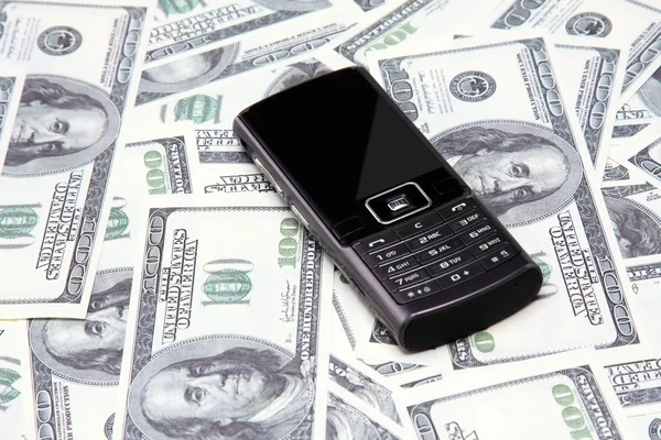 Dollars and mobile phone.