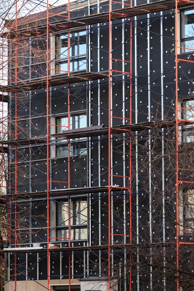 Exterior insulation of building facade under construction