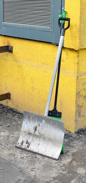Tools for territory cleaning. shovel and sweeper leaned against