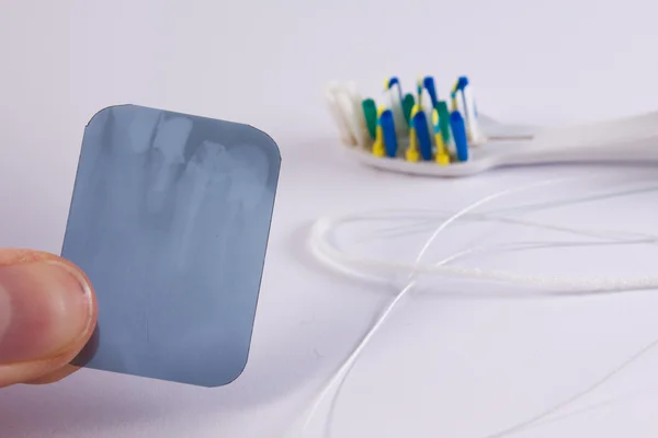 X-ray picture with a toothbrush and a dental floss