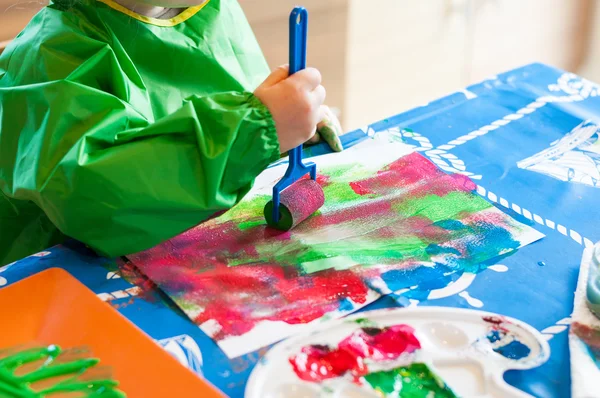 Child painting with roller