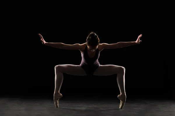 Silhouette ballet dancer in black swimsuit