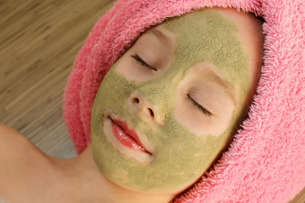 Beautiful girl  with clay mask  facial