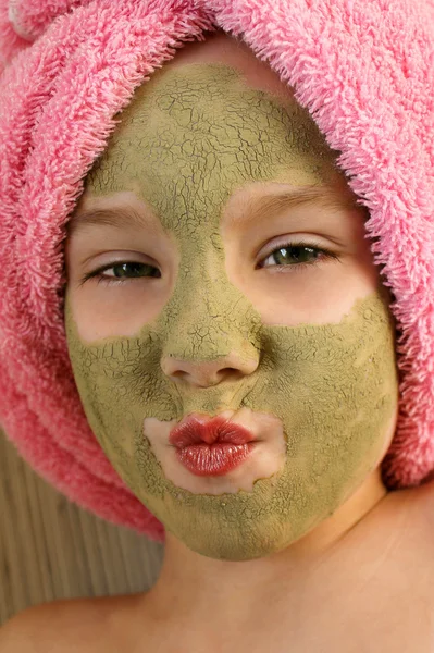 Beautiful girl  with clay mask  facial