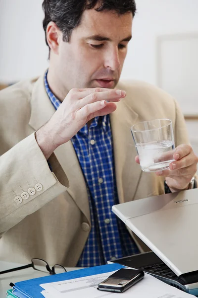 MAN TAKING MEDICATION