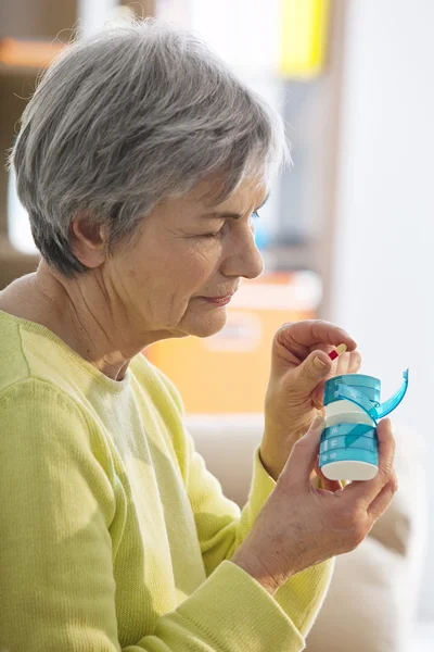 ELDERLY PERSON TAKING MEDICATION