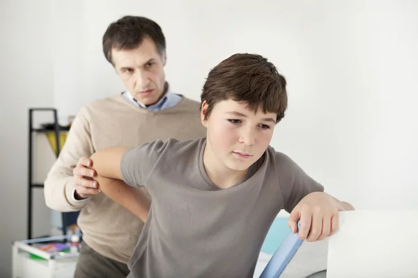 Doctor examines a boy\'s back
