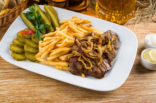 Roast beef, french fries and jug of beer