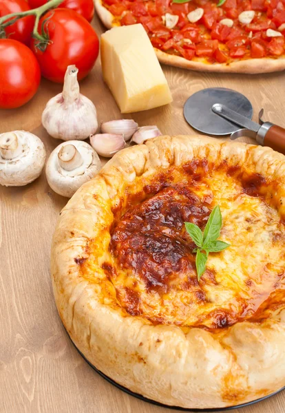 Stuffed pizza with ingredients on a table