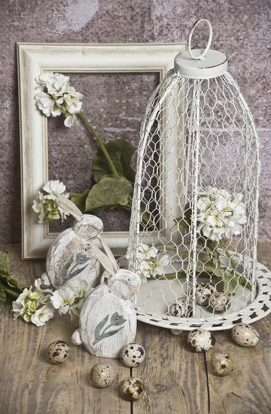 Easter ,eggs in a cage, spring white flowers, quail eggs, white bunnies