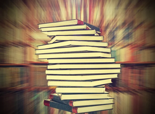 Books on blured bookshelf background, vintage style.