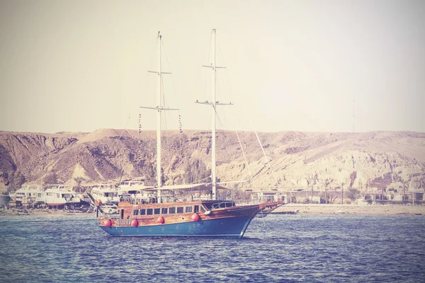 Vintage picture of a sailing boat on the sea in Egypt.