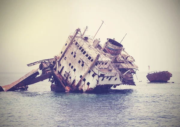 The sunken shipwreck on the reef, Egypt, vintage retro filtered.