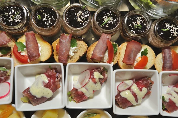Finger food in small white plates - food catering