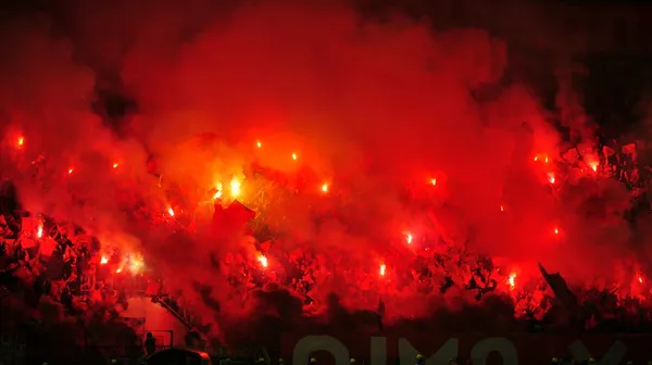 Soccer or football fans using pyrotechnics