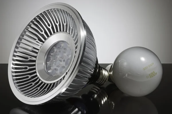 Modern LED and conventional light bulb, closeup