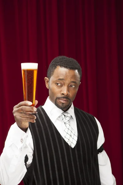 African american bartender in retro suit with beer