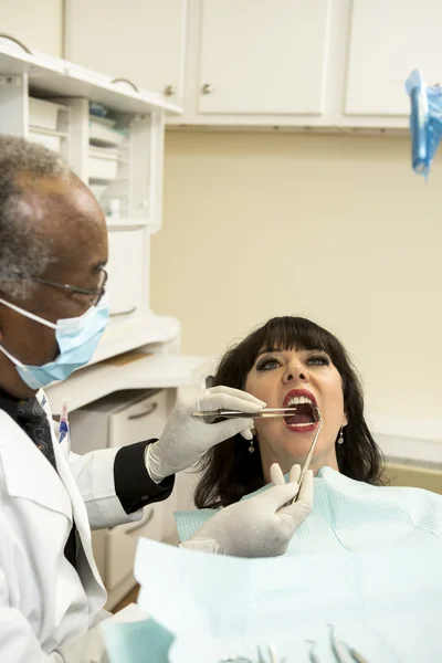 African american dentist performing an oral exam
