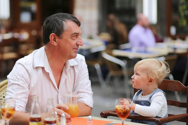 Father and his daughter having fun together in Italian cafe