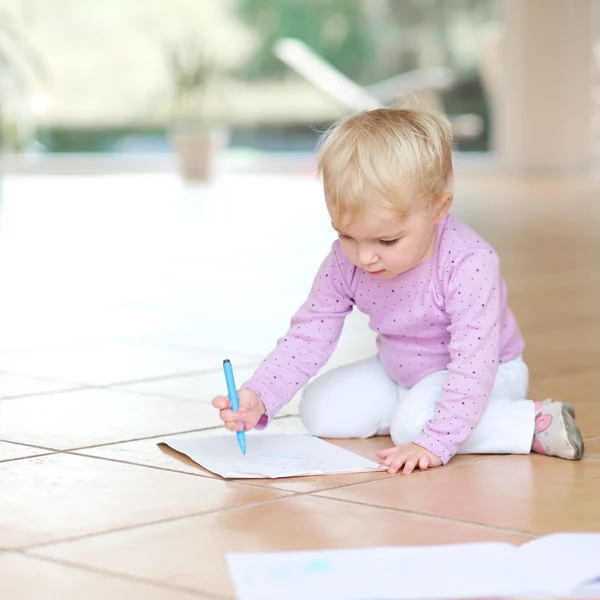 Baby girl drawing with colorful pencils