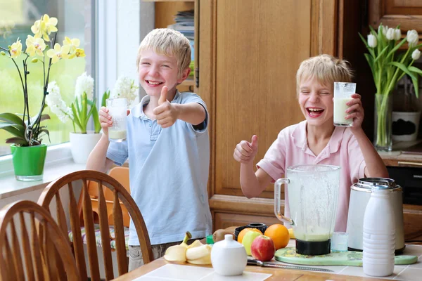 Teenager boys drinking cocktail from milk and fruits