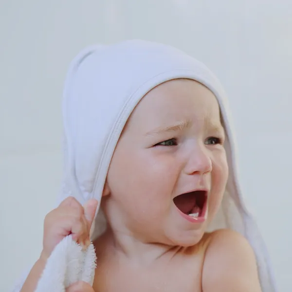 Baby girl under bath towel