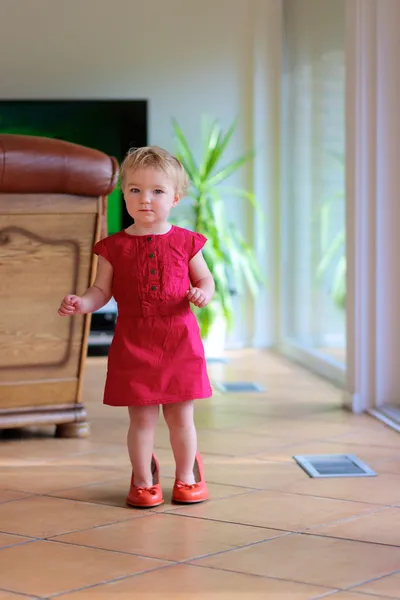 Toddler girl trying mom's shoes