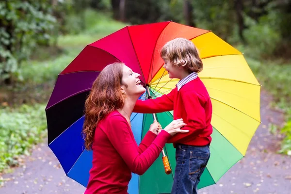 Mother and son under a colorful umbrella