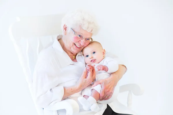 Grandmother singing to her newborn baby grandson