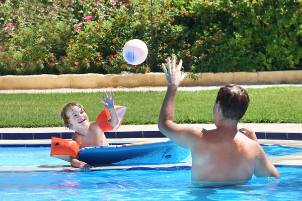 Father and son in a swimming pool