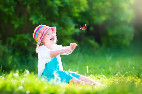 Toddler girl playing with butterfly