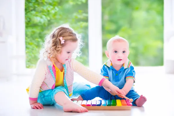 Kids playing music with xylophone