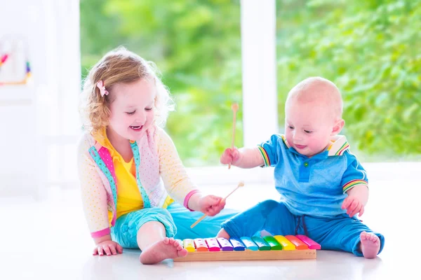 Kids playing music with xylophone