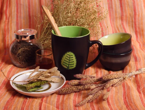 Still life with dried herbs, cups, bowls