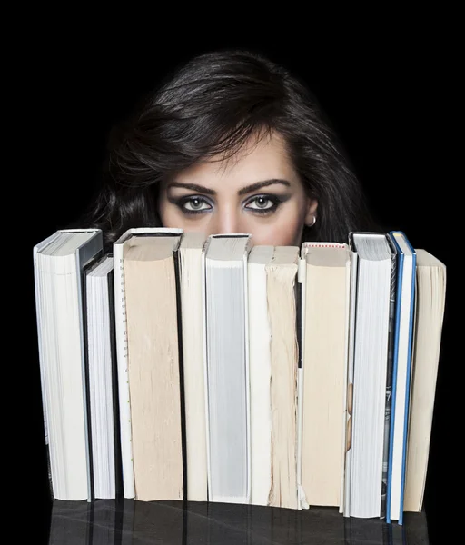 Girl hiding behind book shelf