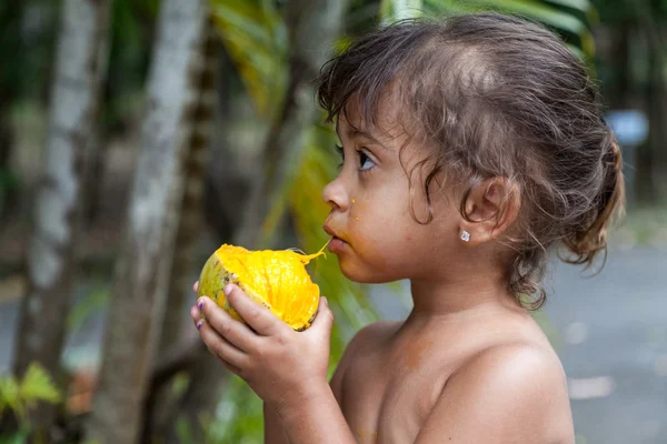 Girl eating mango