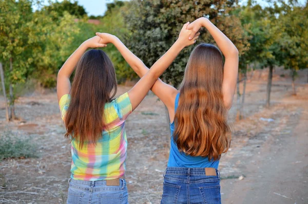 Two best friend girls making a forever sign