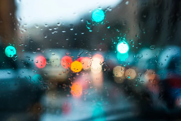 Blurred light through a wet windshield