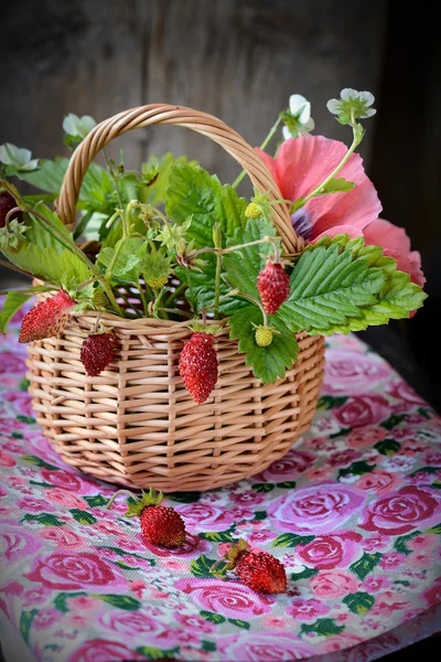 Bouquet of wild strawberries in a basket