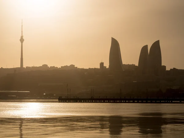 BAKU, AZERBAIJAN - NOVEMBER 22, 2013: Flame Towers in Baku at sunset. Flame Towers are the first flame-shaped skyscrapers in the world and they can be seen from almost any point of the city