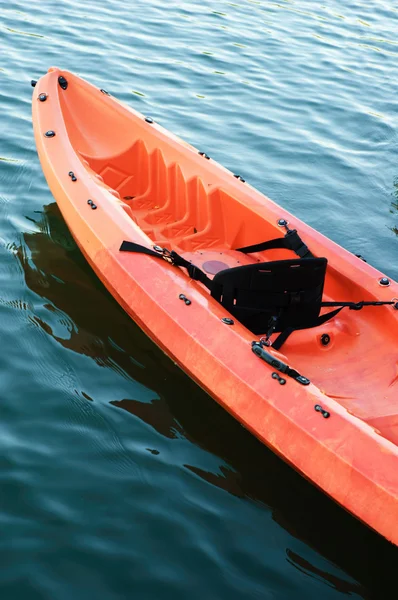 Red kayak on dark water
