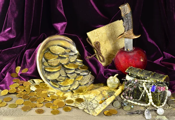 Pirate treasures with map and knife in the apple