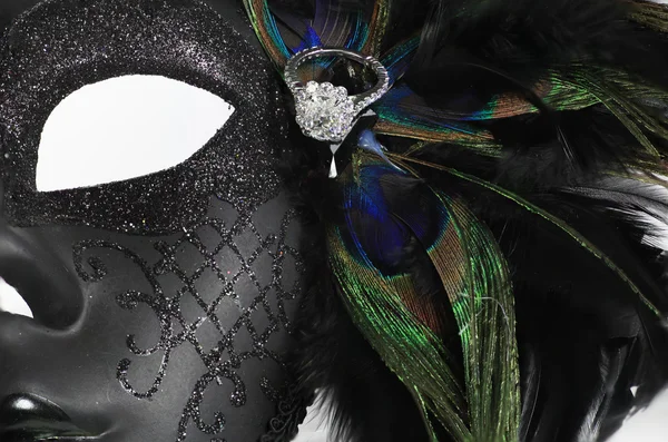 Beautiful diamond ring sitting on top of an elegant mask