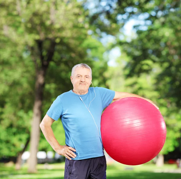 Mature man holding pilates ball