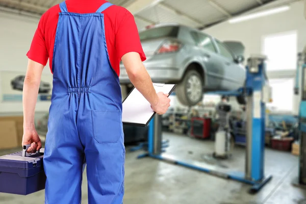 Mechanic in car repair service