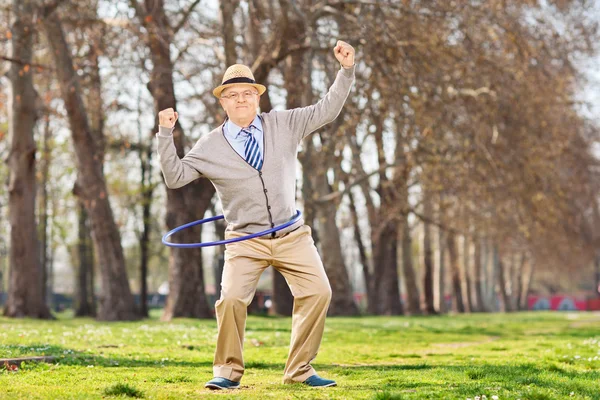 Senior man, exercise with a hula hoop